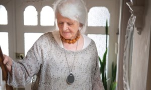 Person wearing a personal alarm walking up stair