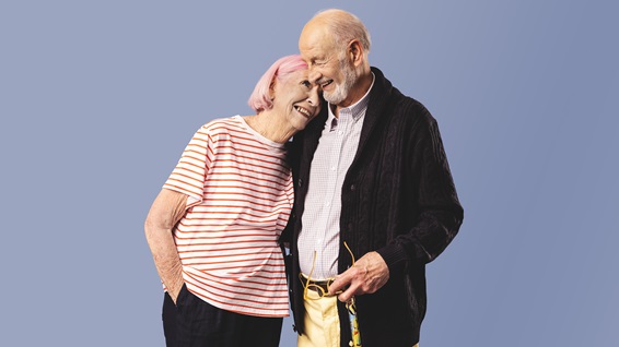 Couple standing with one person leaning on the others shoulder