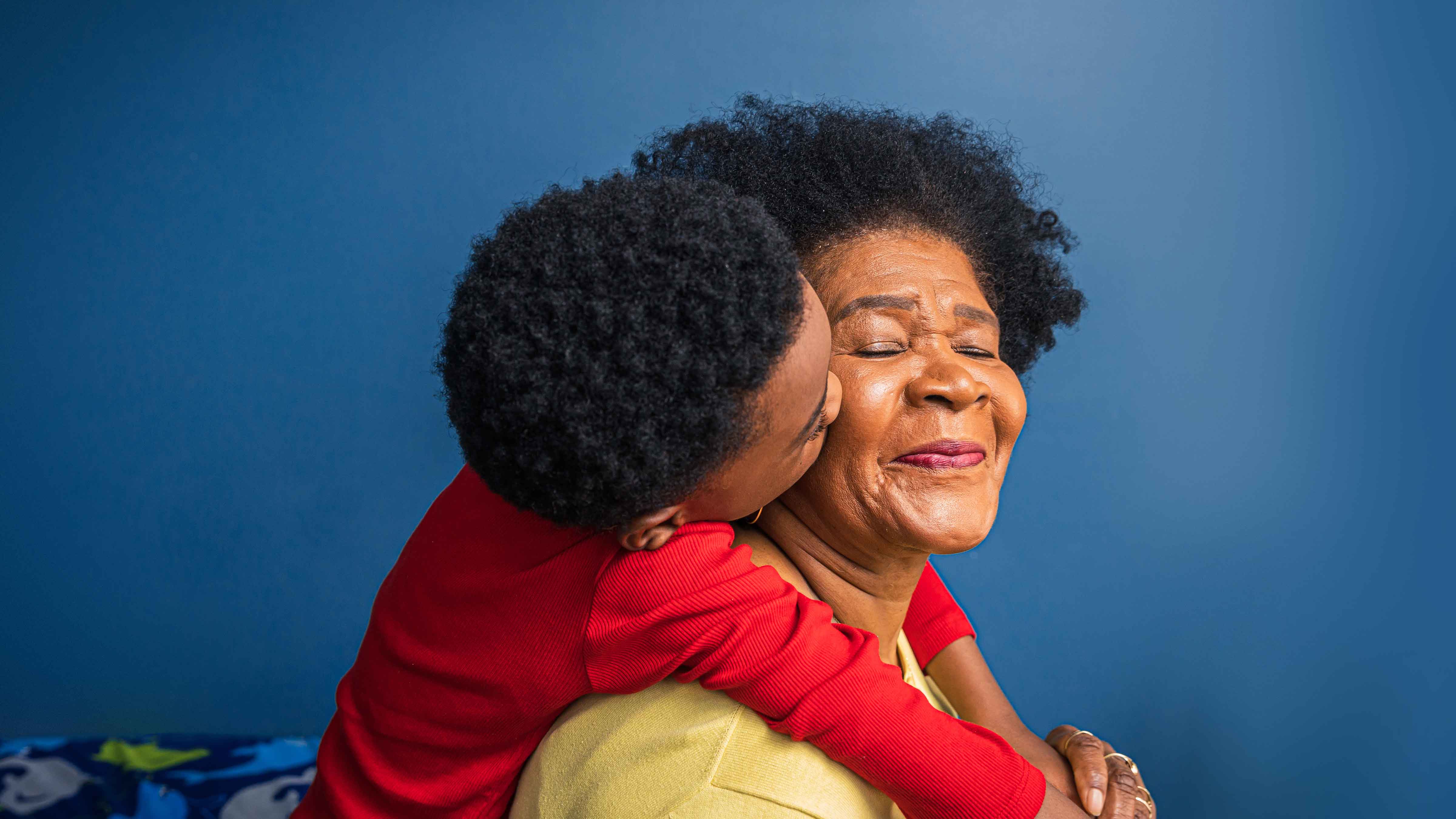 grandmother carrying grandchild 