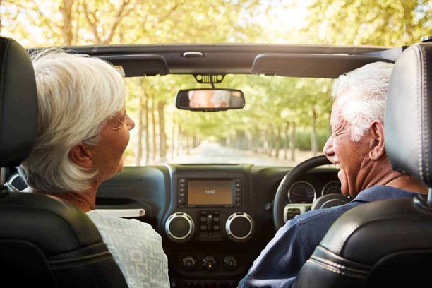 Man and woman laughing in a car