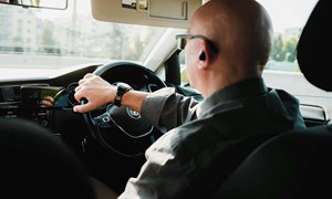 a picture of an older driver behind the wheel of a car