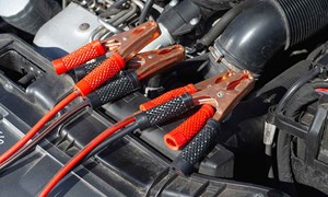 a car engine with jumper cables attached to it