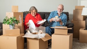Elderly couple packing during their downsize moveug