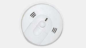 a smoke alarm mounted on a ceiling