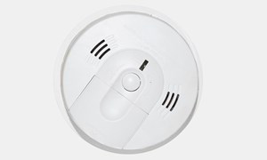 a smoke alarm mounted on a ceiling