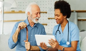 Man with nurse seeing tech options