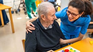 senior man and nurse playing boardgames