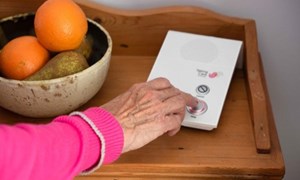 older person calling for help using a personal alarm