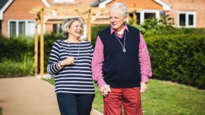 Older couple walking down a street