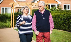 Older couple walking along a street