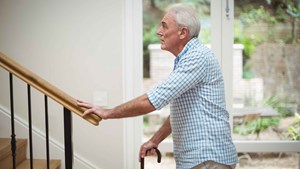 senior-man-climbing-upstairs-with-walking-stick-16-9-compressed.jpg