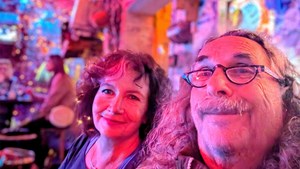 a selfie of a middle aged couple smiling in a budapest ruin bar