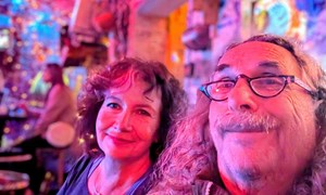 a selfie of a middle aged couple smiling in a budapest ruin bar