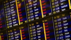 arrival and departure board at an airport showing delays across the board